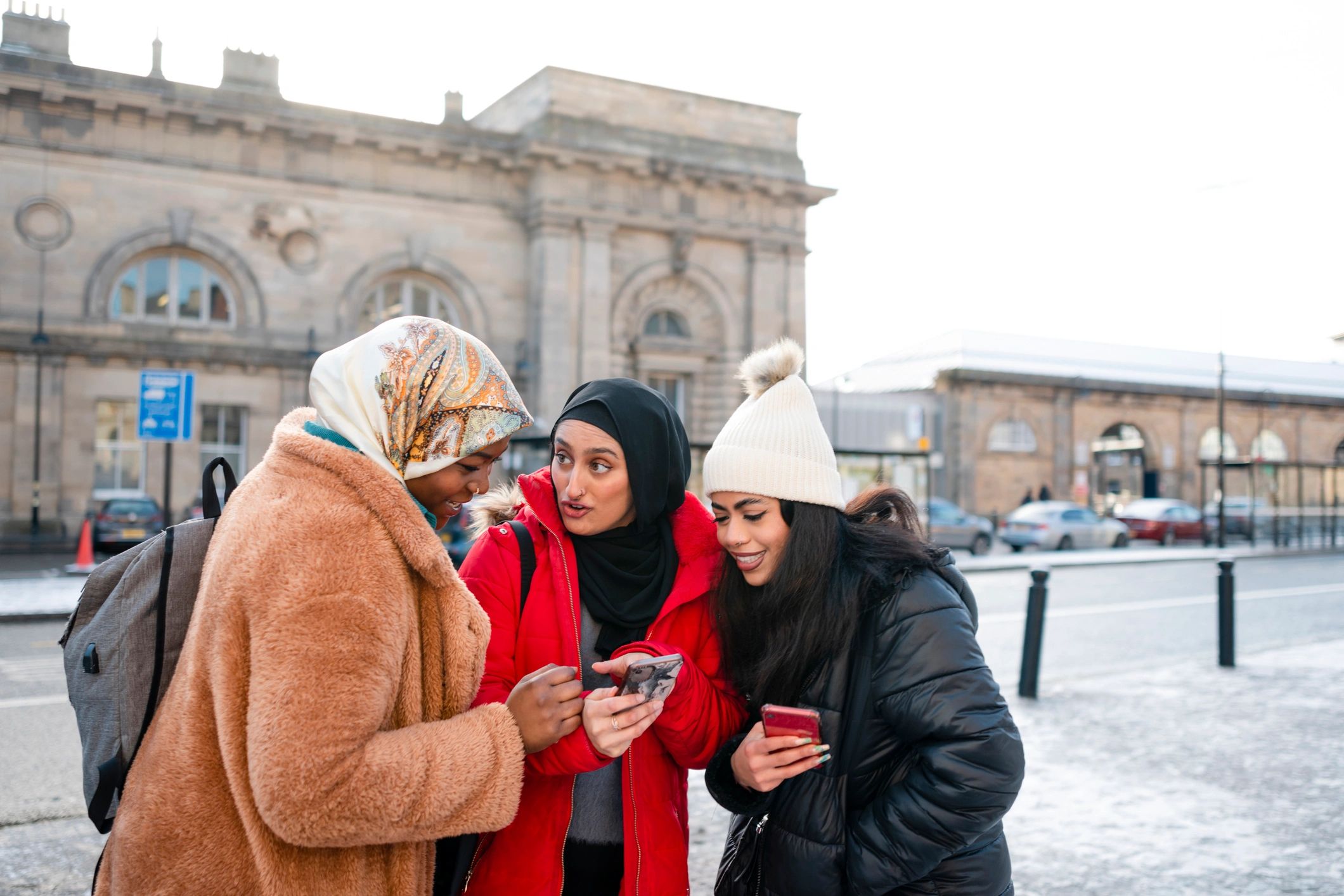 People looking at a smartphone together while shopping