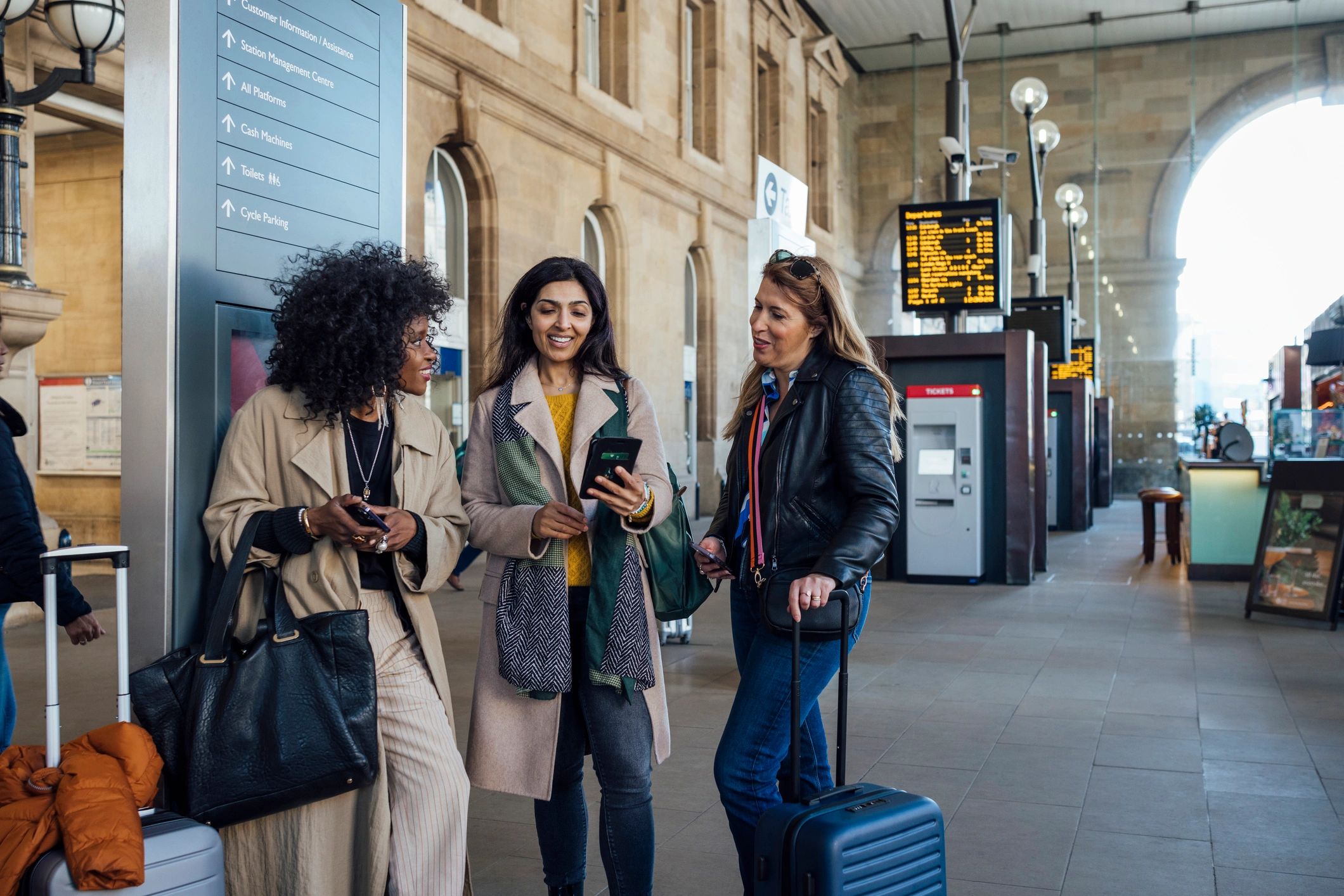 Group gathered together viewing information on a phone
