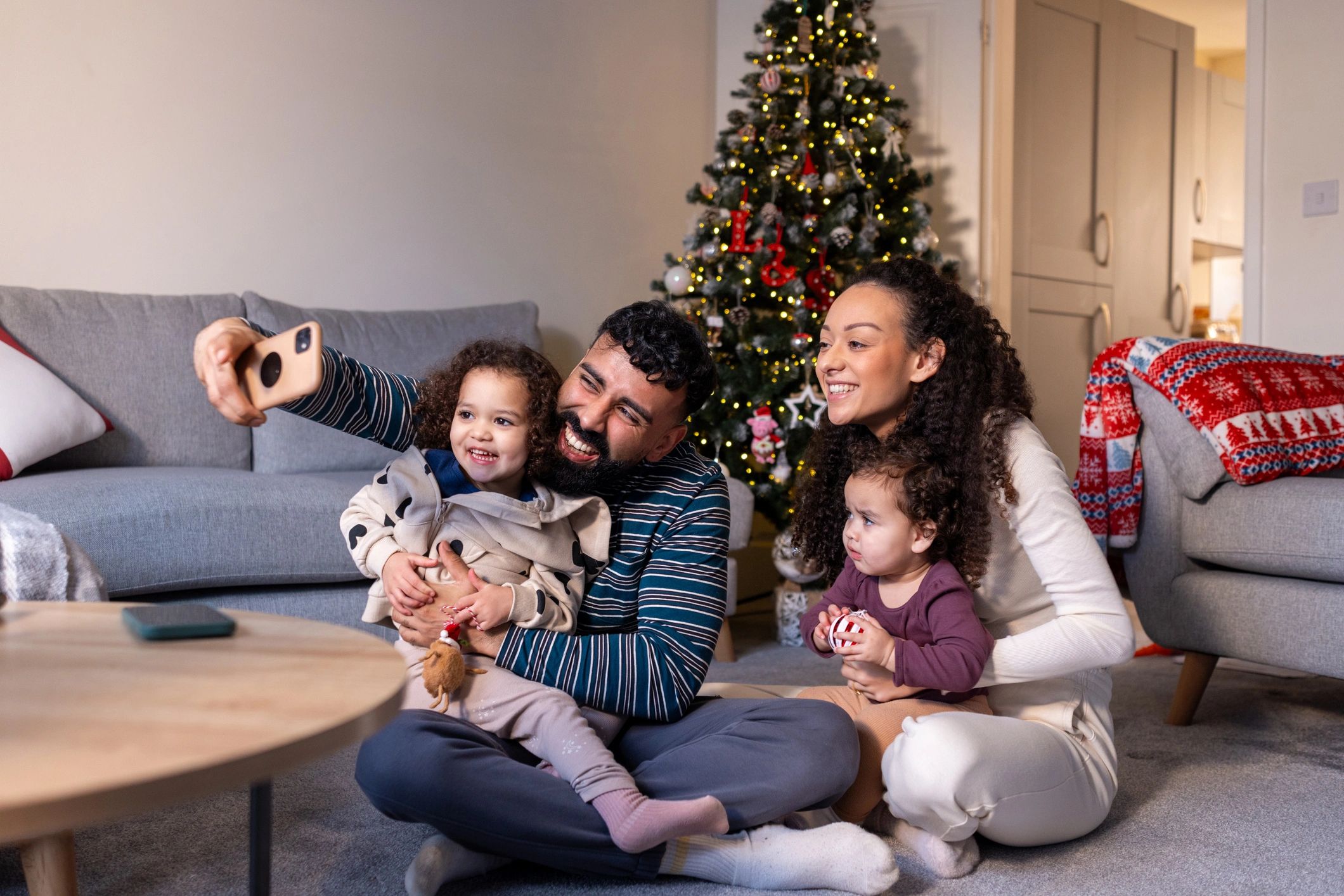 Family using a smartphone together at home