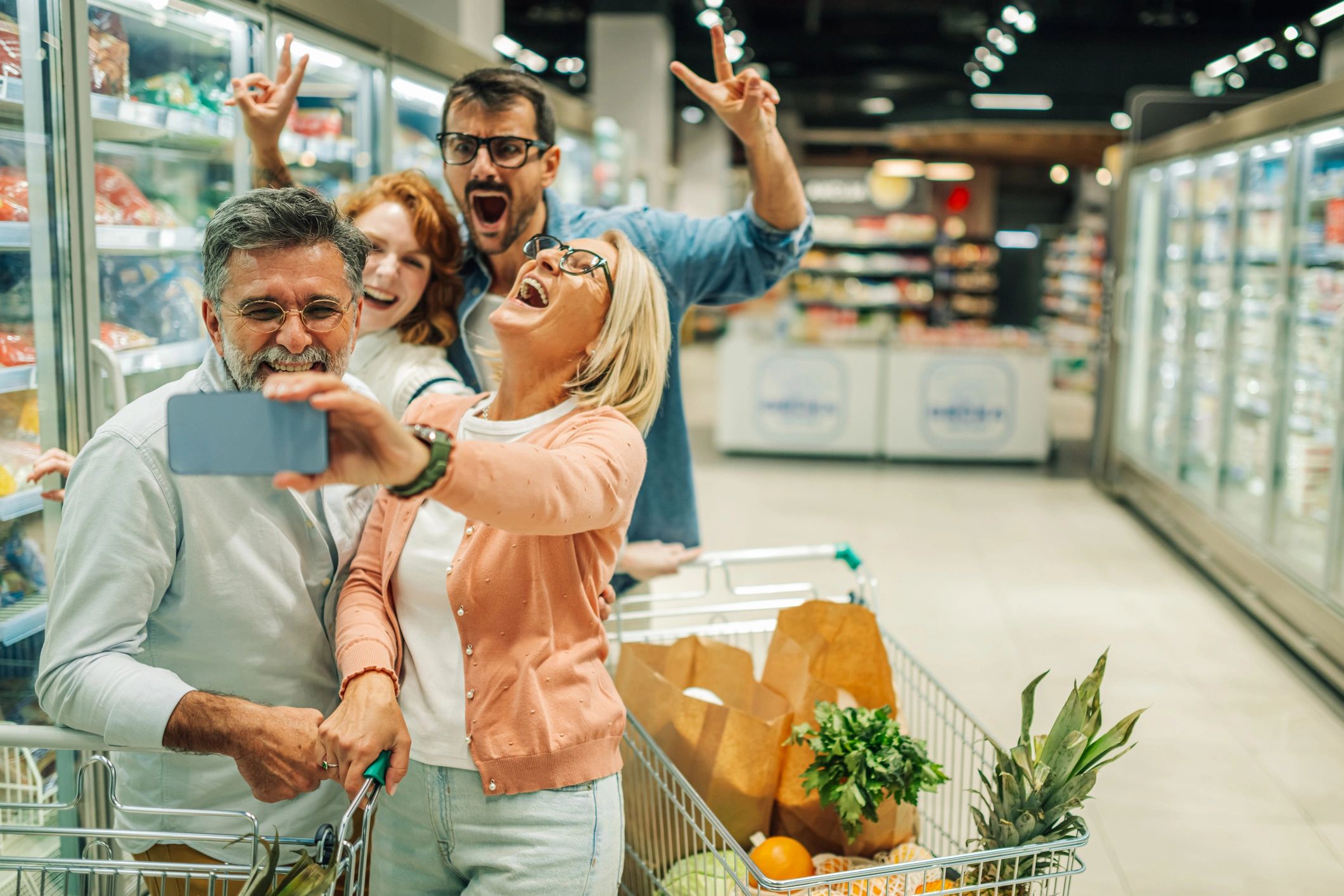 Family in a supermarket aisle checking products