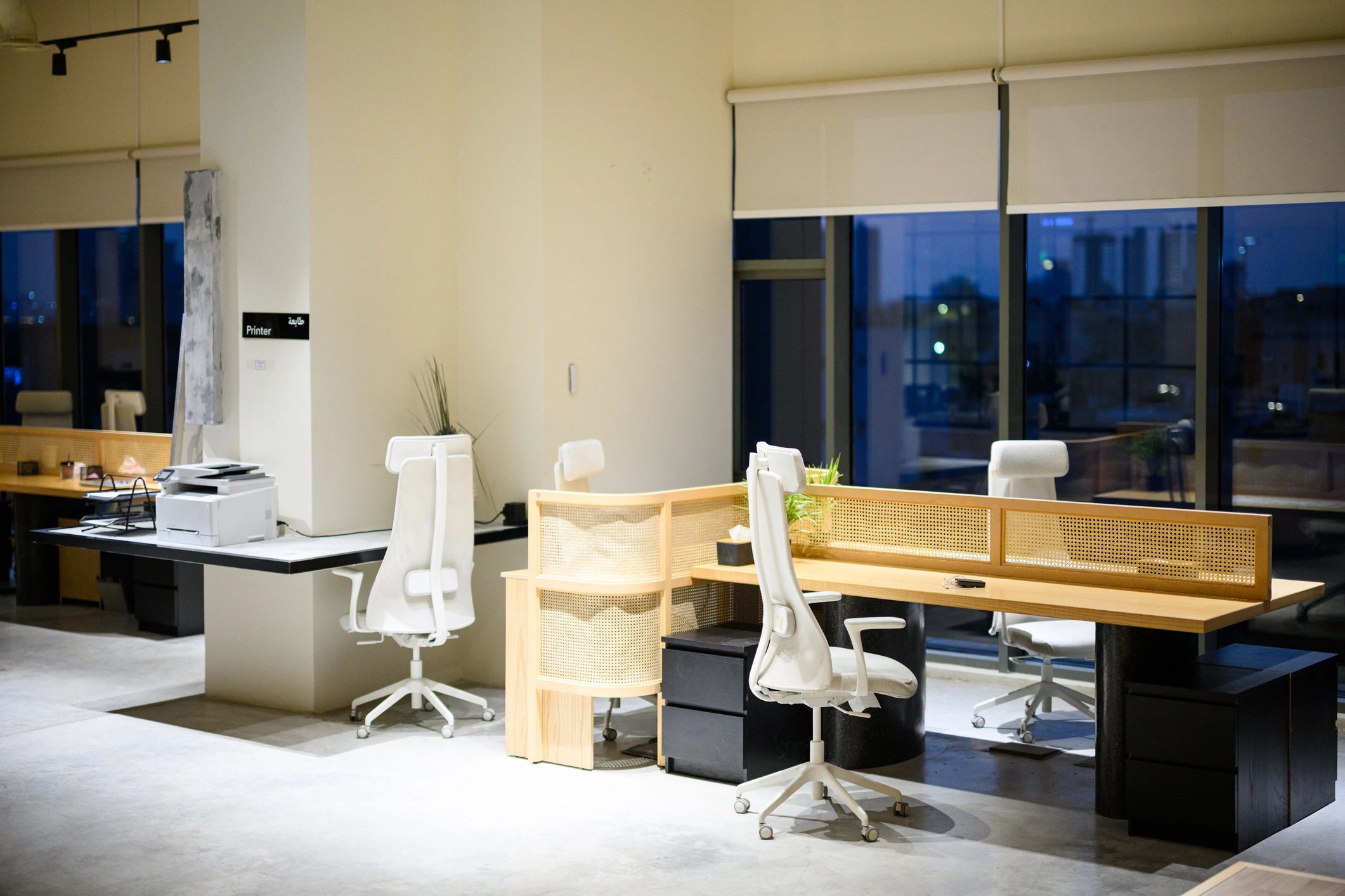 Modern office workspace with desks and city view